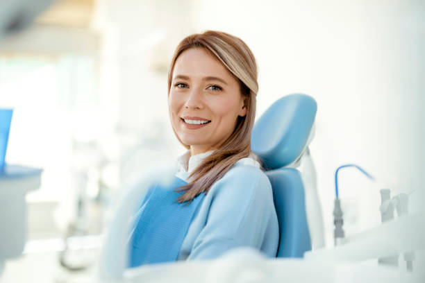 Woman smiling in a dental chair while she waits to have her dental cleaning at the Alexandria Smile Center in Alexandria, LA.